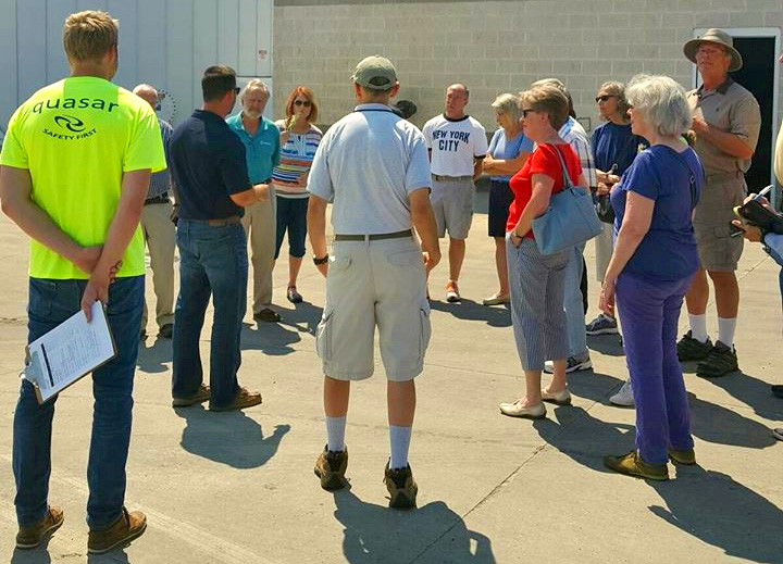 a group of people listening intently to someone else speak