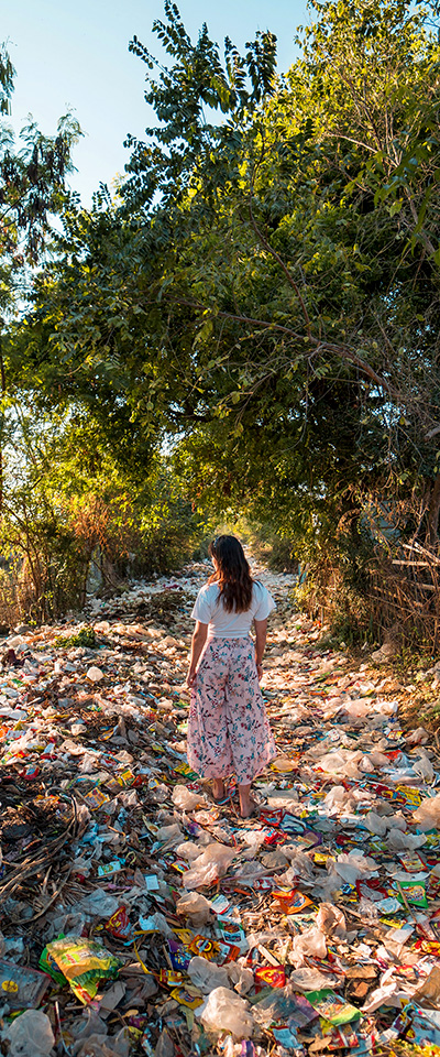 person standing in the middle of polluted land