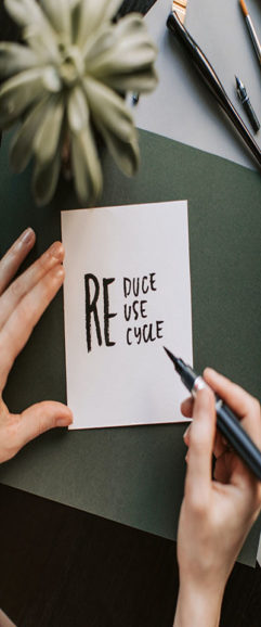 Paper with words written: reduce, reuse, and recycle
